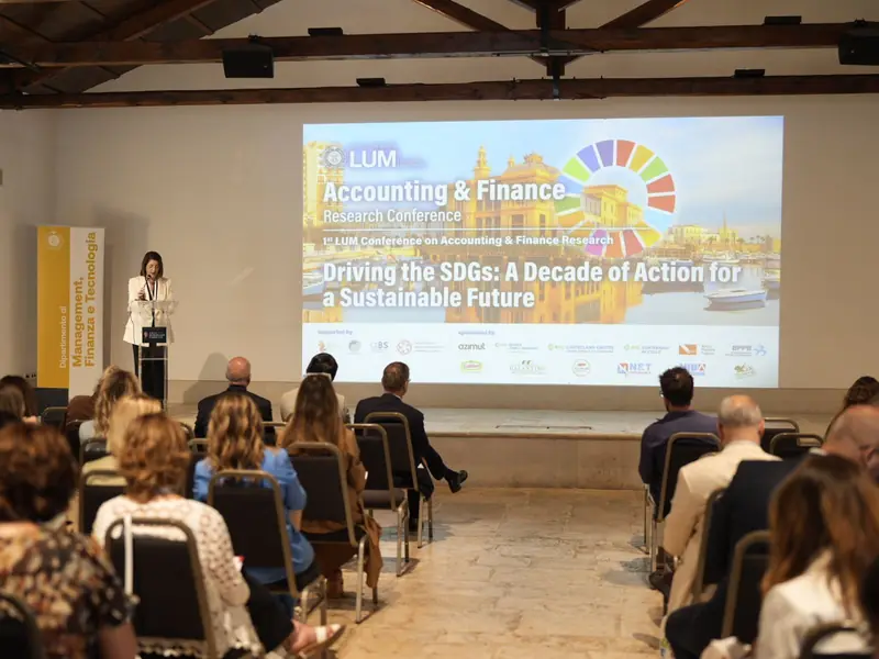 Opening plenary of the first edition in 2025, with the title Driving the SDGs on the screen above the audience.