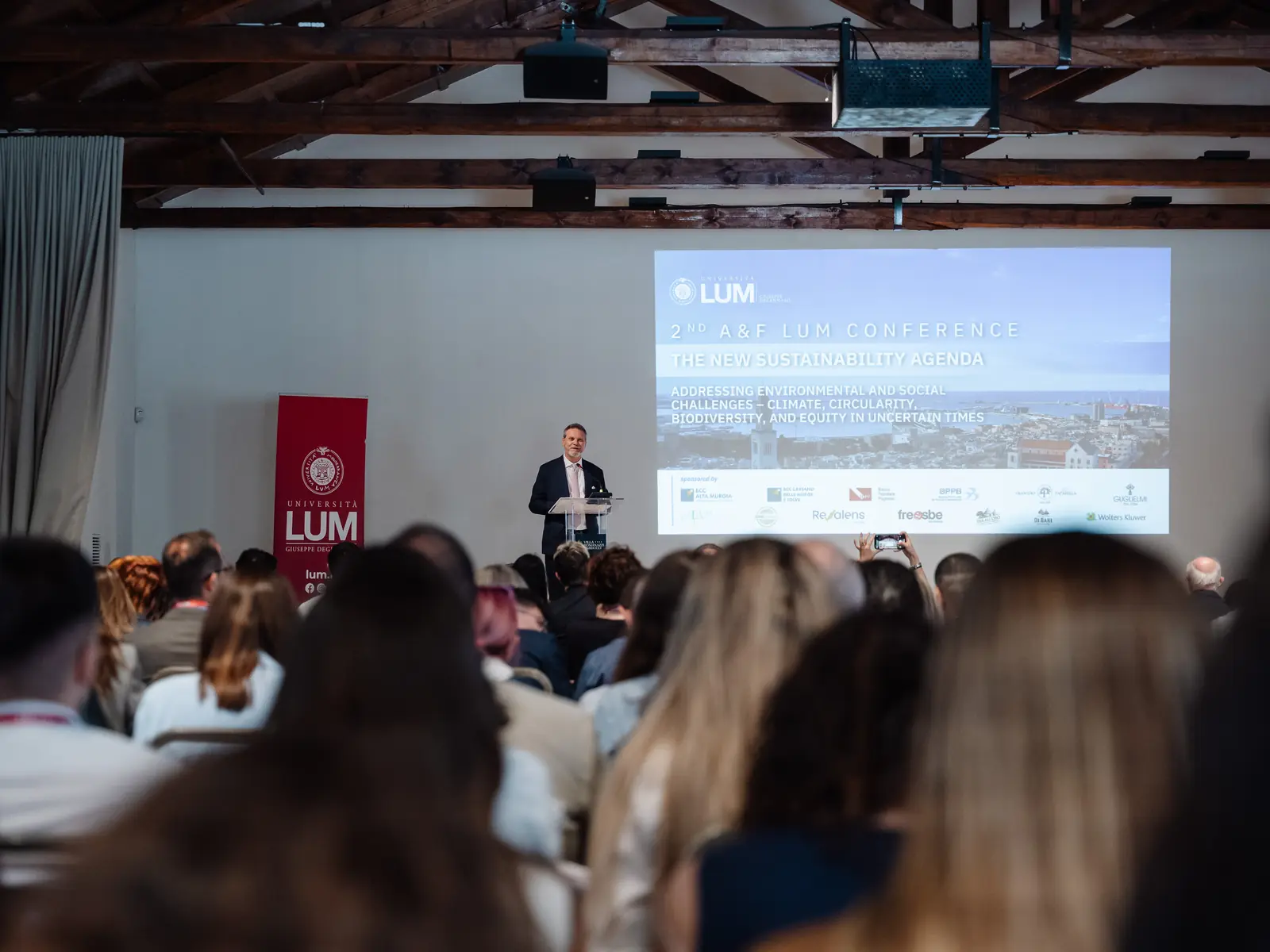 Plenary hall during the 2026 A&F LUM Conference, with the conference theme displayed above the audience.