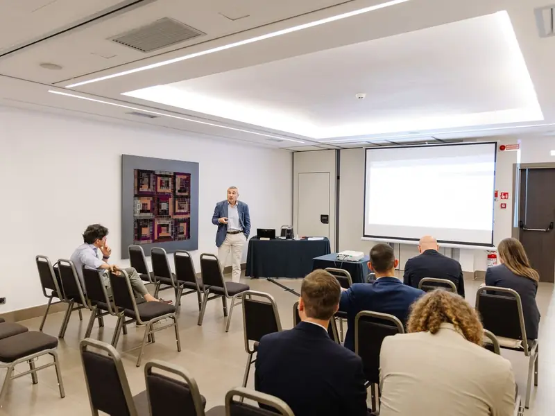 One of the meeting rooms of Villa Romanazzi Carducci during a parallel session, with participants facing the screen.